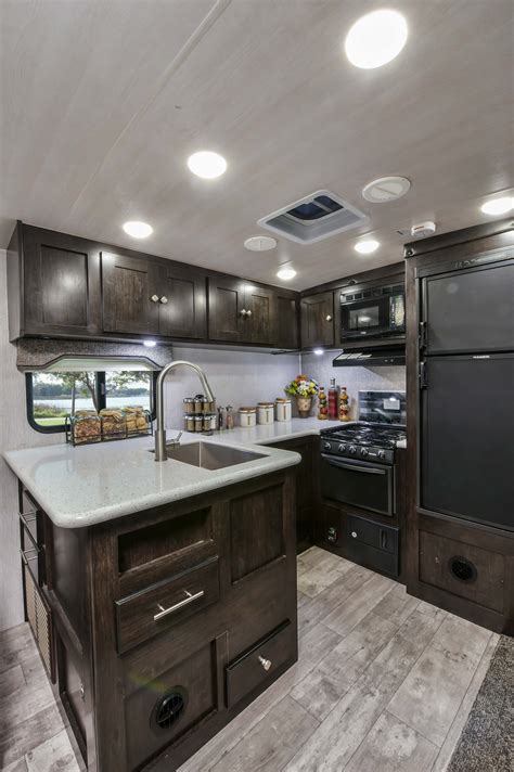 The dinette folds down and this floor plan can sleep 4. Kitchen in the 2018 North Trail 28RKDS rear kitchen travel ...