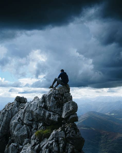 Man Sitting On Cliff Illustration Rock Man Precipice Mountains