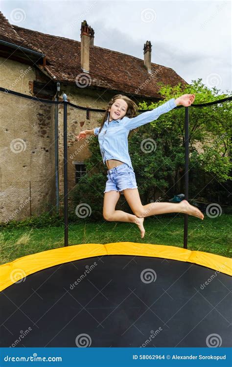 Cute Teenage Girl Jumping On Trampoline Royalty Free Stock Image 58062964