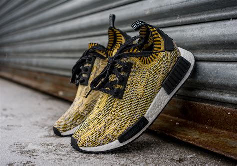 With a modern, unique silhouette that boasted design elements borrowed from some of the most iconic adidas running sneakers of the past, the adidas nmd r1 was a standout model that hit the ground running. adidas NMD Yellow Black - Sneaker Bar Detroit
