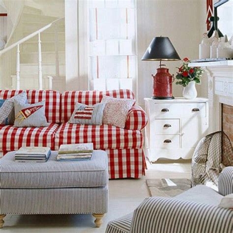 A Red And White Checkered Couch In A Living Room Next To A Fire Place