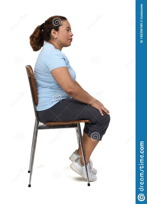 View Of A Woman Sitting On A Chair Look Side On White Background Stock