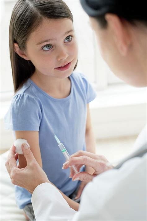 Female Doctor Giving Girl Injection Photograph By Science Photo Library