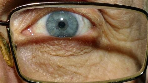 Eye of old man wearing spectacles with red capillaries. Macro Stock Footage,#wearing#spectacles# ...