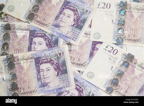 A Pile Of Used Uk Sterling Cash £20 And £10 Notes Stock Photo Alamy