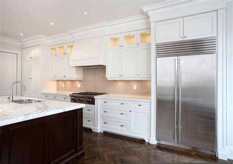 The uptown white cabinets consist of a ½ grade a plywood box with a solid birch 3/4 thick face frame. wood hood, stacked cabinets, column legs next to rangetop | White modern kitchen, White kitchen ...