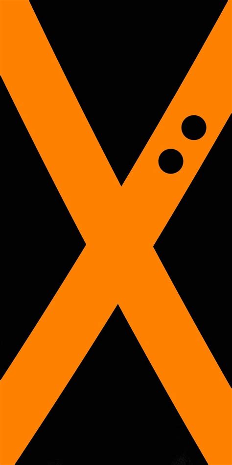 An Orange And Black Traffic Sign With The Letter X On Its Diagonal Stripe