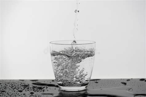 Motion Blur Of Pouring Pure Drinking Water Flow Into The Glass Making
