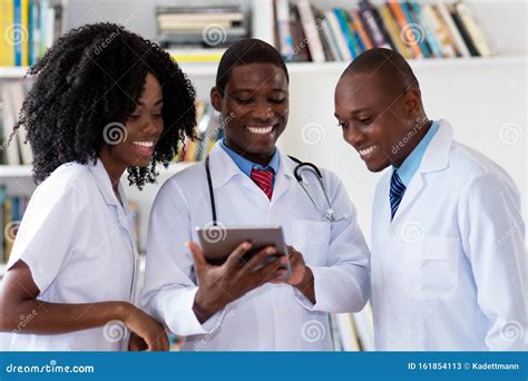 Team Of African American Doctors Talking About Patient Stock Image