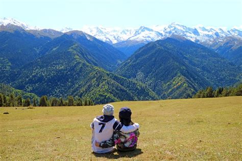 Couple Enjoy The Incredible View Of Snow Capped Caucasus Mountain From
