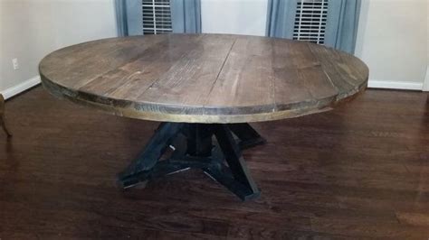 This large round wooden dining table seats 8-10 people ...