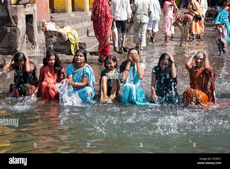 Young Indian Women Bathing In The Sacred Waters Of The Godavari Stock