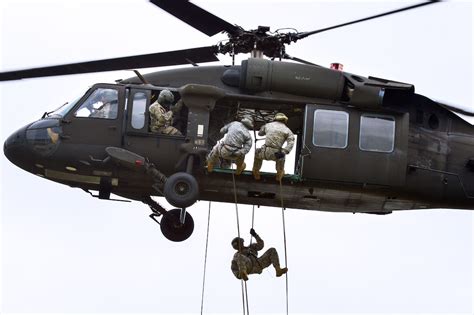 Us Troops Rappel From A Uh 60 Black Hawk Helicopter During An Air