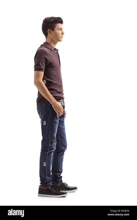Full Length Profile Shot Of A Teenage Boy Waiting In Line Isolated On