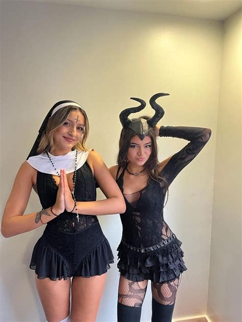 Two Women Dressed Up In Costumes Standing Next To Each Other With Horns On Their Heads