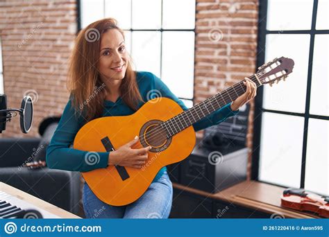 Young Woman Musician Playing Classical Guitar At Music Studio Stock