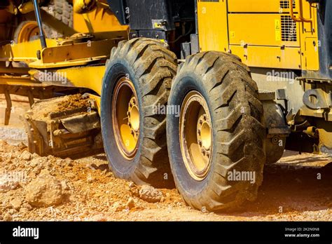 Road Grader Working At Construction Site For Maintenance And