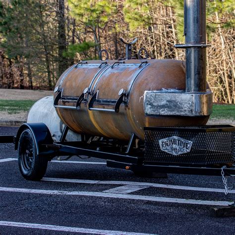 An Old Fashioned Gas Tank Is Parked In A Parking Lot