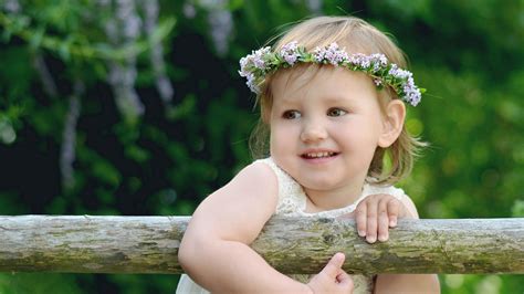 Smiling Cute Baby With White Dress And Flower Crown On