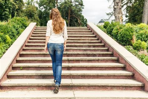 Rear View Of Young Woman Going Up Stairs In Park Stock Photo Image Of