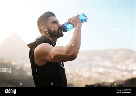 Cooling Off After An Intense Workout A Sporty Young Man Drinking Water