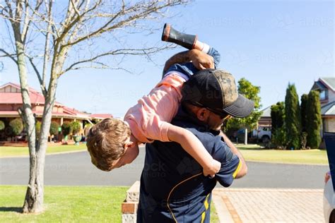 Image Of Father Carrying Child Upside Down Over Shoulder Austockphoto