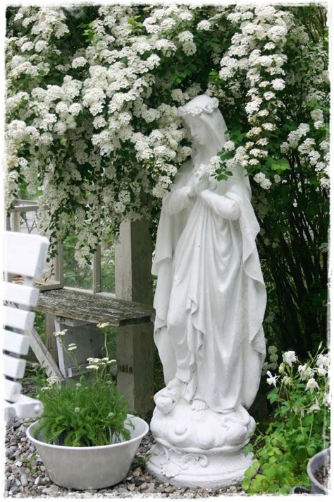 Beautiful Blessed Mother Garden Statue Surrounded By Flowers
