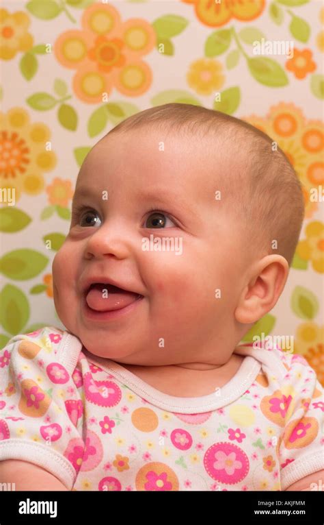 A Happy Six Month Old Baby Posing In Floral Patterns Stock Photo Alamy