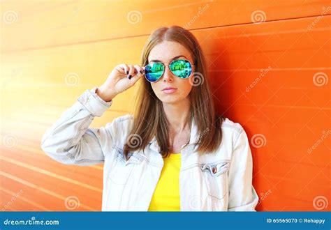 Portrait Beautiful Woman In Sunglasses Over Colorful Orange Stock Photo