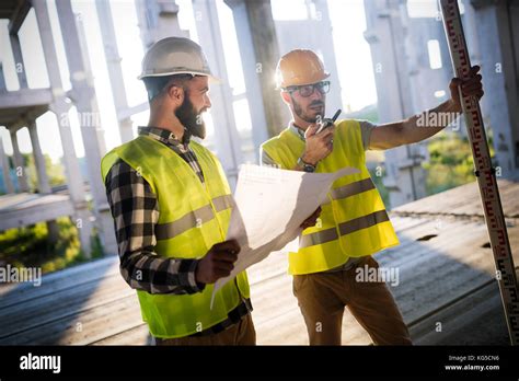 Portrait Of Construction Engineers Working On Building Site Stock Photo