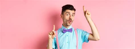Premium Photo Cheerful Funny Man Dancing In Bowtie And Suspenders Pointing Fingers Up And