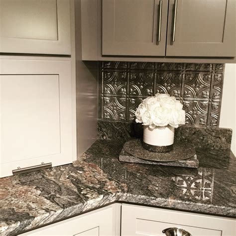 My brother wants brushed nickle in the kitchen, it will have. Gray cabinets, brushed nickel handles, faux tin back ...