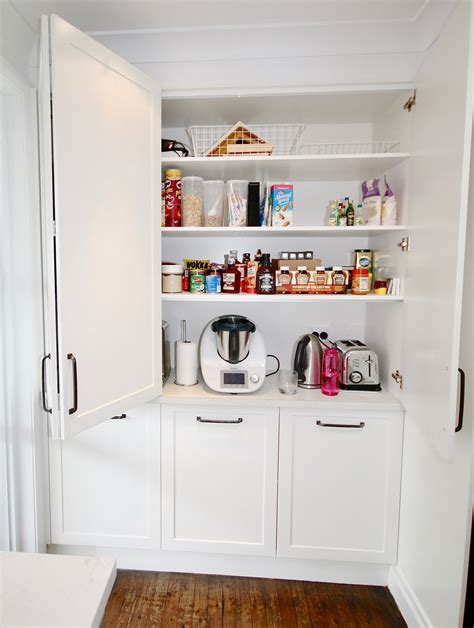 Appliance Cabinet Fitted With Bifold Doors And Adjustable Shelving