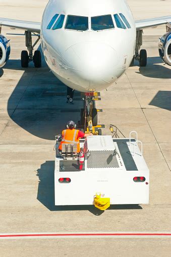 Airport Tow Truck Pushing Airplane To The Runway Stock Photo Download