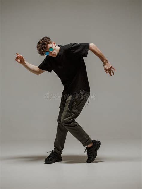 Guy Dancing Contemporary Dance In Studio Neutral Grey Background