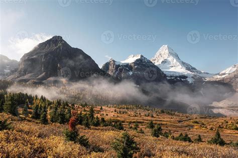 Mount Assiniboine With Foggy And Blue Sky On Lake Magog In Autumn