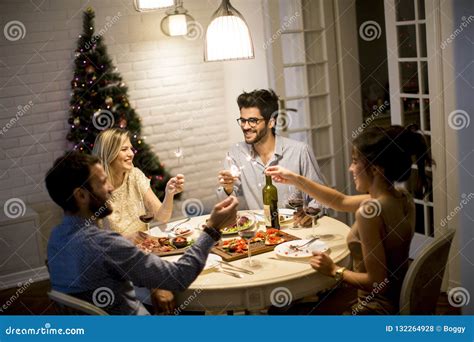 Friends Celebrating Christmas Or New Year Eve At Home Stock Photo
