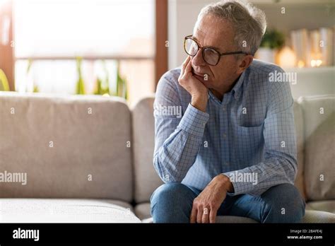 Worried Senior Man Sitting Alone In His Home Stock Photo Alamy