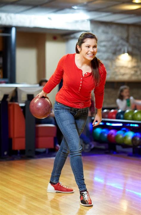 Happy Young Woman Throwing Ball In Bowling Club Stock Photo Image Of