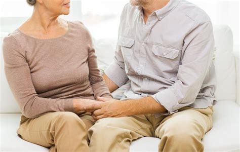 Close Up Of Senior Couple Holding Hands At Home Stock Photo Image Of