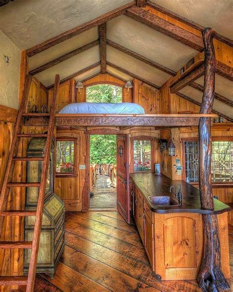 The Inside Of A Log Cabin With Stairs Leading Up To The Loft And