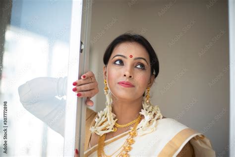 An Young And Attractive Indian Woman In White Traditional Wear Is