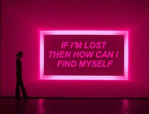 a person standing in front of a pink wall with the words if i m lost then how can i find myself