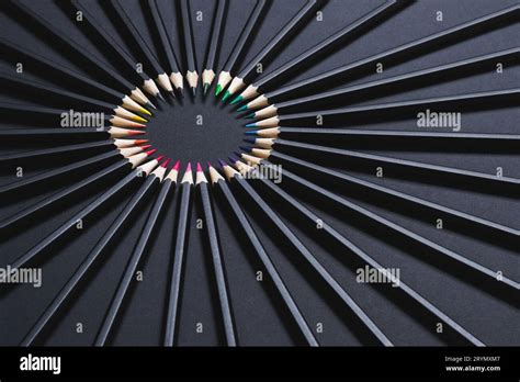 Colored Pencil Set Arranged In Circle On Black Background Stationery