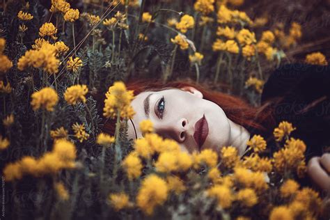 Red Haired Woman Laying In Flowers By Stocksy Contributor Ani Dimi