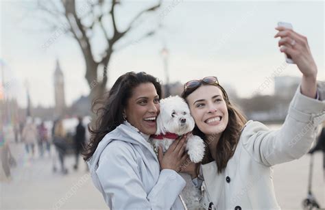 Lesbian Couple With Dog In Urban Park London Uk Stock Image F019