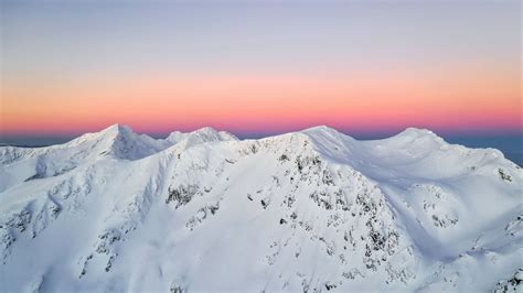 Download Wallpaper 1600x900 Mountain Peaks Snowy Horizon Sky