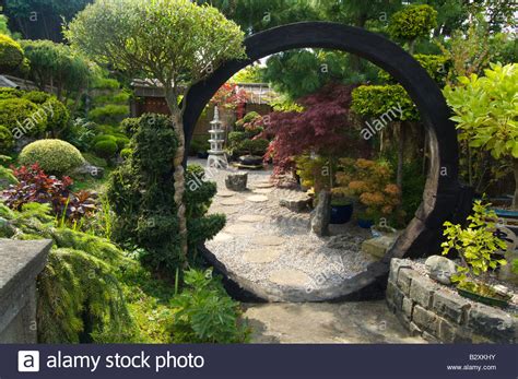 Japanese Style Garden With Moon Gate Rocks Shrubs And