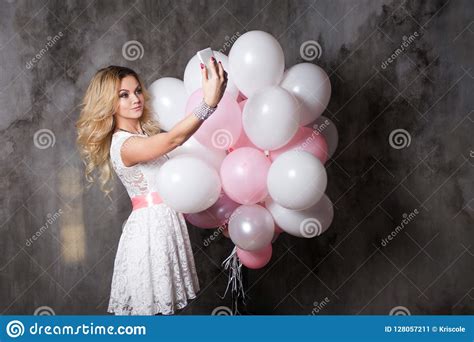 Charming Young Blonde In A White Dress With Pink Balloons Make A