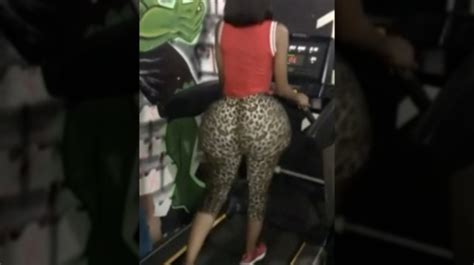 chick with a massive fake booty walking on a treadmill